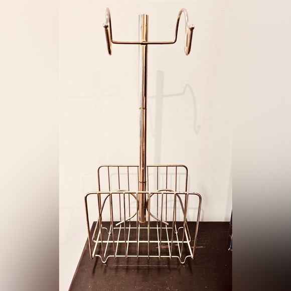 1970s Hollywood Regency brass towel caddy with magazine holder below.